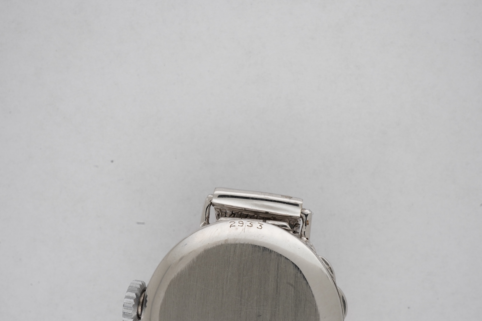 A lady's early 1940's platinum and diamond set manual wind cocktail watch, on a 9ct white gold mesh link bracelet